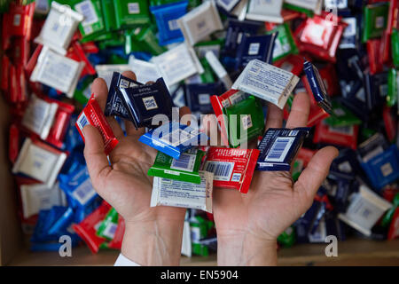 Waldenbuch, Germany. 16th Apr, 2015. A staff member of chocolate manufacturer Ritter Sport presents miniature editions of chocolate bars with different flavours at the production site of Ritter Sport in Waldenbuch, Germany, 16 April 2015. Photo: Marijan Murat/dpa/Alamy Live News Stock Photo