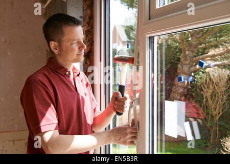 Construction Worker Installing New Windows In House Stock Photo