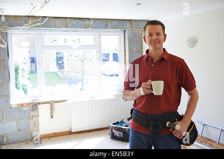 Builder Carrying Out Home Improvements Taking A Break Stock Photo