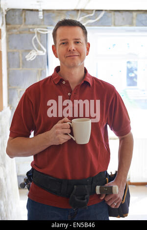 Builder Carrying Out Home Improvements Taking A Break Stock Photo