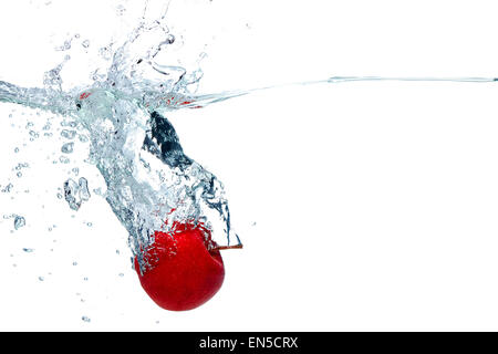 Apple falls deeply under water Stock Photo