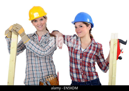 Female builders with timber Stock Photo