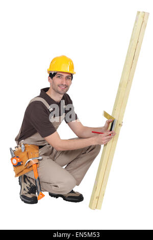 Tradesman taking measurements using a try square Stock Photo