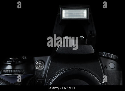 Professional modern DSLR camera with open flash, low key image Stock Photo