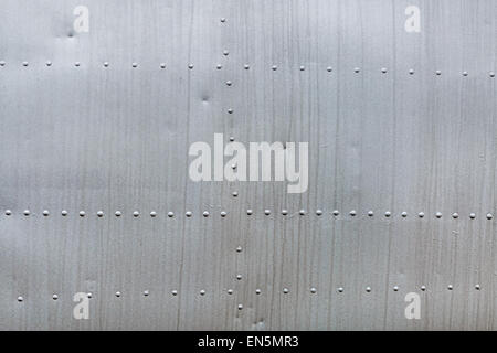 Abstract weathered metallic background. Riveted metal from aircraft. Stock Photo