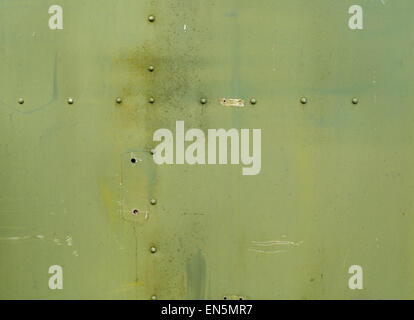 Abstract painted matte green metal background with rivets. Riveted ...