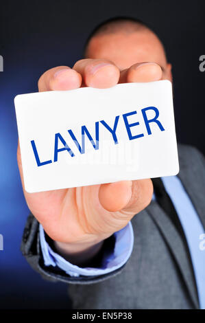 a young caucasian man wearing a gray suit shows a signboard with the word lawyer written in it Stock Photo
