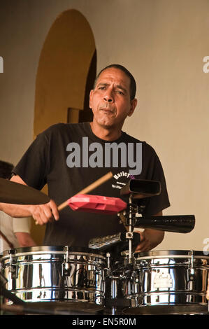 Vertical portrait of the drummer in a live salsa band in Trinidad, Cuba. Stock Photo