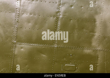 Military green metal plates background texture with seams and rivets. Riveted metal from aircraft. Stock Photo