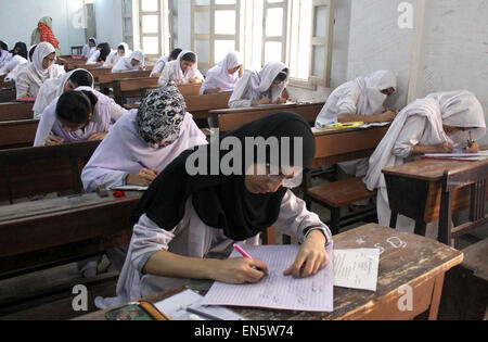 Intermediate students solve examination papers during Annual Examination 2015 at an examination hall as the Intermediate Examinations have been started in Karachi under regional education board on Tuesday, April 28, 2015. Stock Photo