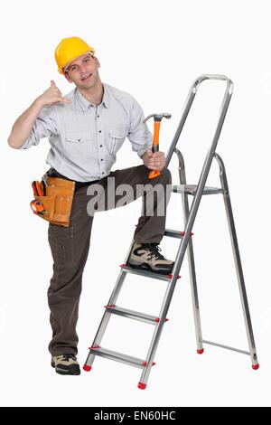 craftsman making a call sign with his hand Stock Photo