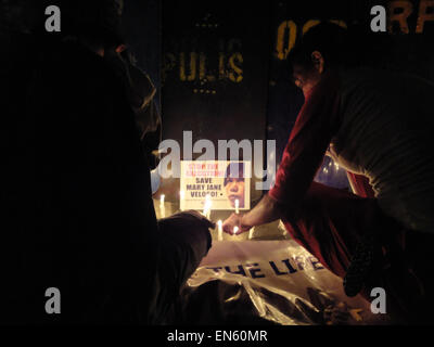 Filipino activists light candles in front of policemen, in support of Filipino death row prisoner Mary Jane Veloso, during their second night of vigil outside the Indonesian Embassy, as the appeal to halt Veloso's execution. Despite an emergency meeting between Indonesian President Joko Widodo and an Indonesian migrant group to stop the execution of the so-called 'Bali Nine,' which includes Veloso, Indonesian attorney general HM Prasteyo says that they will continue to mete out the punishment to the drug convicts, saying that doing otherwise would create a 'precedent' in their campaign against Stock Photo
