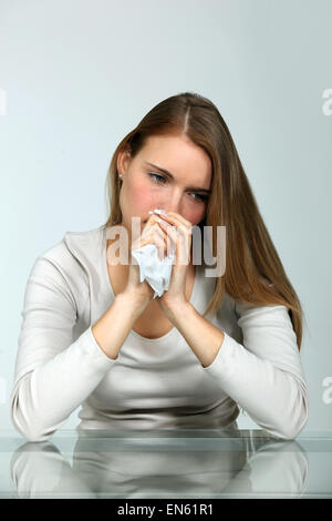 Woman at a table with a tissue Stock Photo