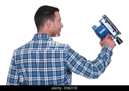 Man using powered sander Stock Photo