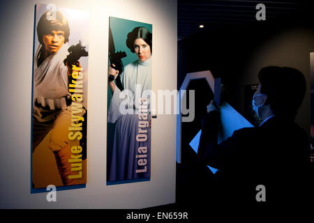 Tokyo, Japan. 28th Apr, 2015. A member of the press takes pictures of the image of Luke Skywalker and Leia Organa during a press tour of the exhibition Star Wars Vision at the Tokyo City View Sky Gallery in Roppongi Hills on April 28, 2015, Tokyo, Japan. The exhibition is divided into six themed areas (Original, Force, Battle, Saga, Galaxy and Droid) located in different halls, and visitors can see models of the battle spaceships, life-size statues of the principal characters and Jedi weapons from the movies. Credit:  Aflo Co. Ltd./Alamy Live News Stock Photo