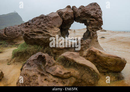 Arch Rock at the Yeliu (Yehliu) Geopark in Taiwan at a rainy and overcast day. Stock Photo