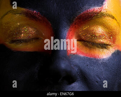 Portrait of a mysterious woman with artistic make-up on her face. Isolated on black background Stock Photo