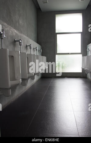 public restroom - urinals in a row Stock Photo