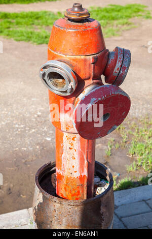 Red used fire hydrant, close up vertical photo Stock Photo