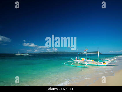 traditional boats on tropical puka beach in boracay philippines Stock Photo