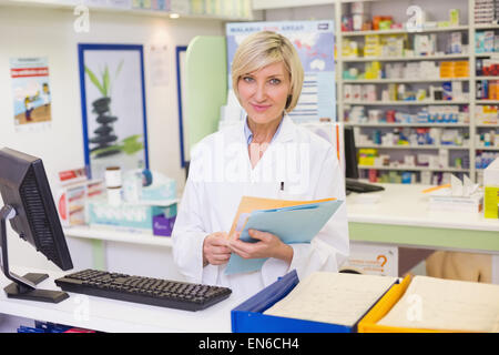 Pharmacist files documents Stock Photo