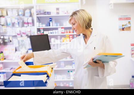 Pharmacist files documents Stock Photo