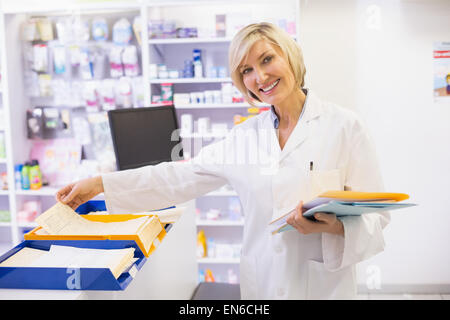 Pharmacist files documents Stock Photo