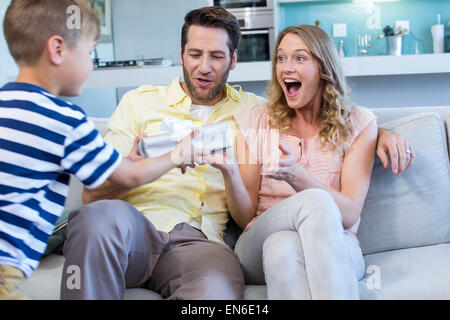 Son surprising his mother with gift Stock Photo