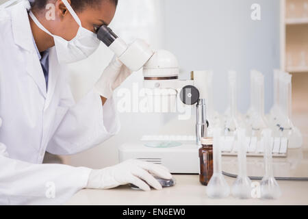 Scientist looking in microscope Stock Photo