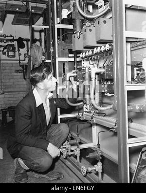 Picture to accompany the "Robot Revolution" feature which ran in the Daily Mirror newspaper on the week commencing 27th June 1955. Picture shows: An instrument mechanic inspects the works of an electronic temperature indicator at the Esso refinery which c Stock Photo