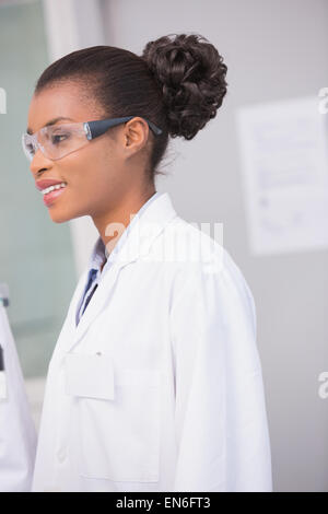 Smiling scientist wearing protective glasses Stock Photo