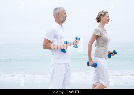 Fit couple lifting dumbbells Stock Photo