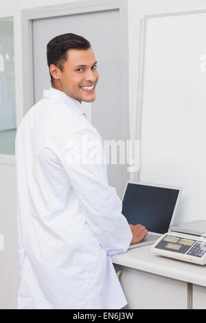 Happy scientist using laptop Stock Photo