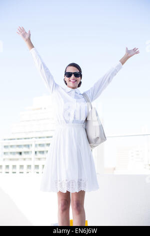 Happy woman raising her hands up Stock Photo