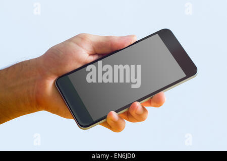 Hand holding a black smartphone Stock Photo