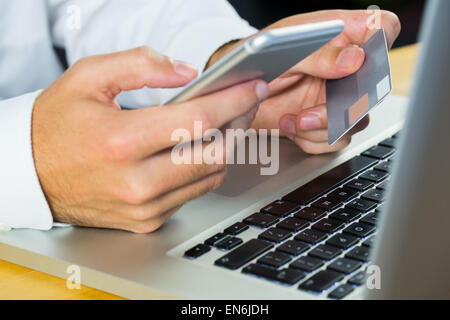 Man using laptop and smartphone Stock Photo