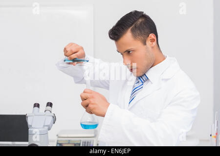 Serious scientist doing tube tests Stock Photo