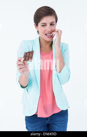 Woman choosing to eat chocolate or not Stock Photo