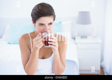 Thoughtful  woman drinking cup of tea Stock Photo