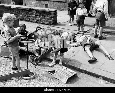 London Kiddies Prepare for 'Soap Box Derby'. A number of soap box Derby races are being arranged for London and provincial towns by several organizations. Many scouts will take part and an artist at Borehamwood is helping boys who will test their trollies Stock Photo