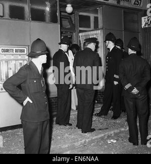 Scenes in and around Bramley Road in Notting Hill, where police were called to prevent trouble between black and white residents in the area. There were several scuffles and some people were arrested and taken away in police vans. Police speaking to a sho Stock Photo