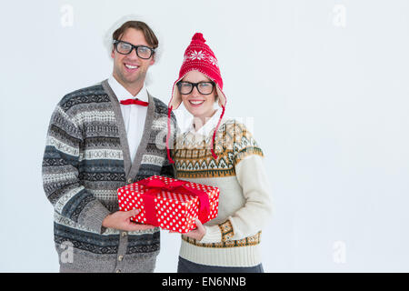 Geeky hipster couple holding present Stock Photo