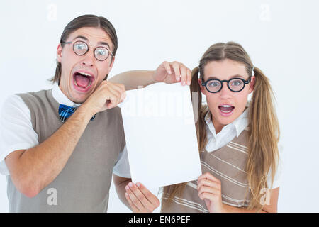 Geeky hipsters holding a poster Stock Photo