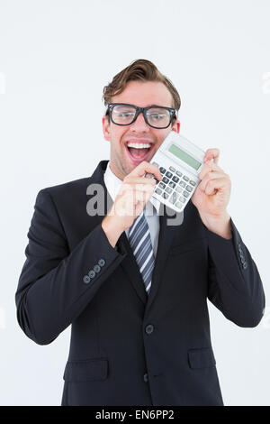 Geeky businessman pointing to calculator Stock Photo