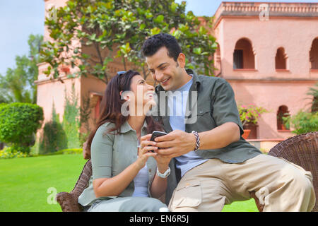 Couple with a mobile phone smiling Stock Photo