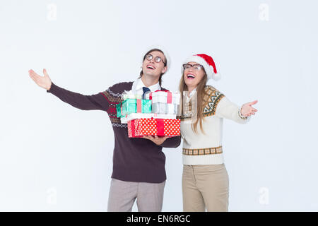 Geeky hipster couple holding presents Stock Photo
