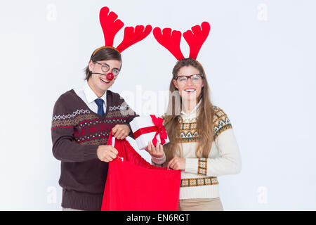 Happy geeky hipster couple holding present Stock Photo