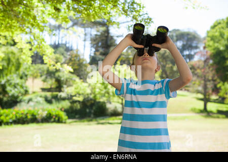 Cute little girl looking through binoculars Stock Photo