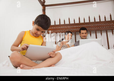 Boy playing on digital tablet Stock Photo