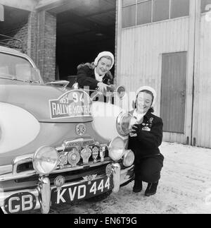 Glaswegian sisters, Chris and Andy Neill from Tollcross, Glasgow, Scotland, will be competing in this years Monte Carlo Rally, Sunday 16th January 1955. This is the 2nd year they've entered and the girls - Andy aged 28 (crouching), & Chris 26 sent off on Stock Photo